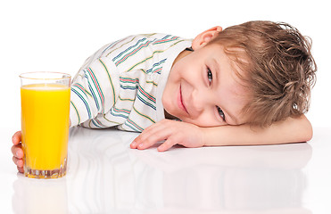 Image showing Little boy drinking orange juice