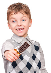 Image showing Little boy eating chocolate