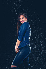 Image showing Young beautiful woman under splash of rain