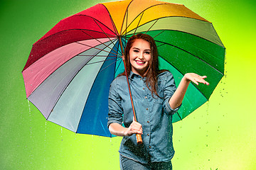 Image showing Young beautiful woman with an umbrella.