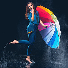 Image showing Young beautiful woman with an umbrella.