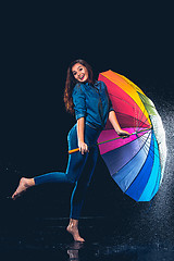 Image showing Young beautiful woman with an umbrella.