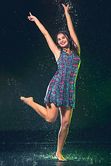 Image showing Young beautiful woman under splash of rain