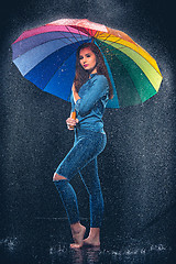 Image showing Young beautiful woman with an umbrella.