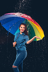 Image showing Young beautiful woman with an umbrella.