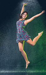 Image showing Young beautiful woman under splash of rain