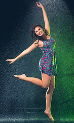 Image showing Young beautiful woman under splash of rain