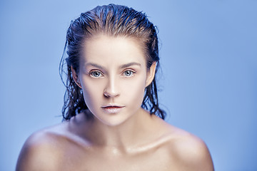 Image showing Beautiful woman face portrait close up on blue