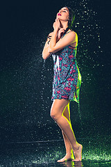 Image showing Young beautiful woman under splash of rain