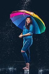 Image showing Young beautiful woman with an umbrella.