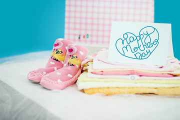 Image showing The baby clothes with a gift box