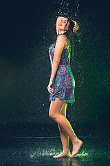 Image showing Young beautiful woman under splash of rain