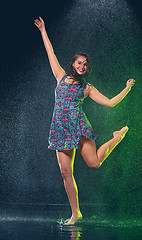 Image showing Young beautiful woman under splash of rain