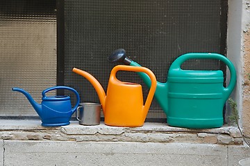 Image showing Three watering cans