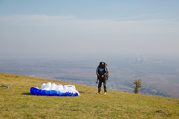 Image showing Paraglider preparing for takeoff