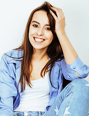 Image showing young pretty teenage hipster girl posing emotional happy smiling on white background, lifestyle people concept 