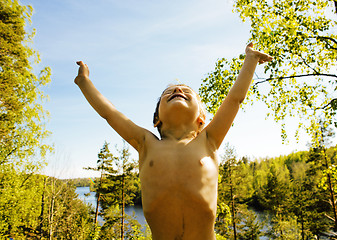 Image showing little cute real boy among tree hight, outdoor lifestyle concept close up