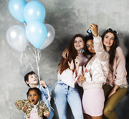 Image showing Lifestyle and people concept: young pretty diversity nations woman with different age children celebrating on birth day party together happy smiling, making selfie. African-american, asian and caucasi