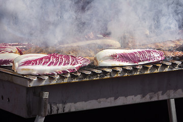 Image showing Grilled pork ribs and red chicory on the grill