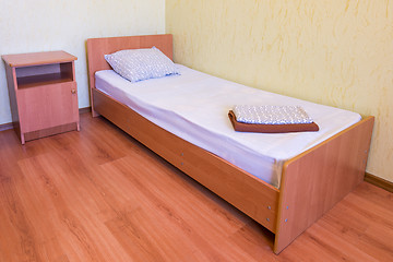 Image showing Sleeper - a bed and a bedside table in the interior of the room, close-up