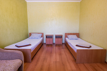 Image showing Sleeps - bed and two bedside tables in the interior of the guest room in the house, close-up