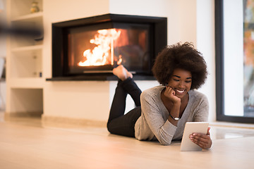 Image showing black women using tablet computer on the floor