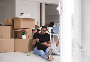 Image showing African American couple relaxing in new house