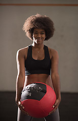 Image showing black woman carrying crossfit ball