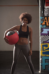 Image showing black woman carrying crossfit ball