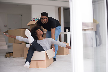 Image showing African American couple  playing with packing material