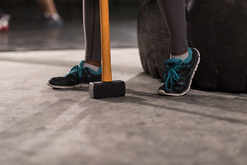 Image showing black woman after workout with hammer with focus on legs