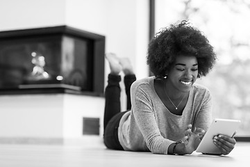 Image showing black women used tablet computer on the floor