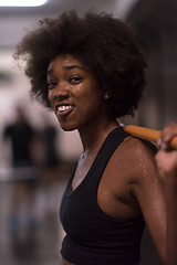 Image showing black woman lifting empty bar