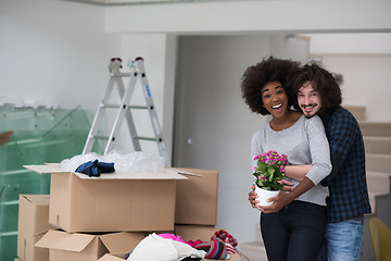 Image showing multiethnic couple moving into a new home