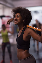 Image showing black woman lifting empty bar