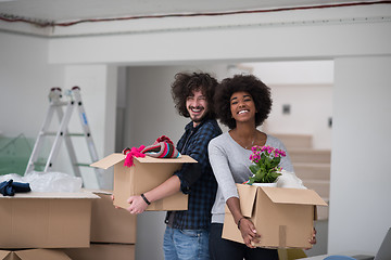 Image showing multiethnic couple moving into a new home