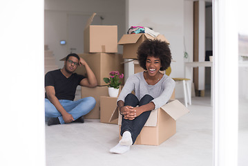 Image showing African American couple  playing with packing material