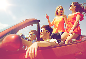 Image showing happy friends driving in cabriolet car