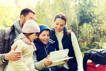 Image showing happy family with tablet pc and backpacks at camp