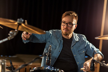 Image showing male musician playing drums and cymbals at concert