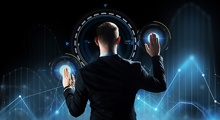 Image showing businessman touching virtual screen