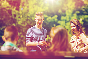 Image showing group of teenage students with tablet pc outoors