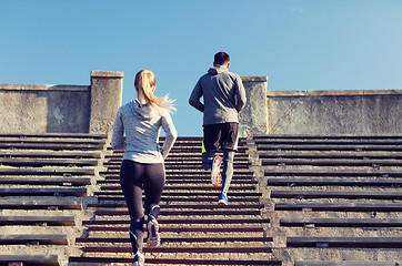 Image showing couple running upstairs on stadium