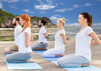 Image showing people making yoga in hero pose outdoors