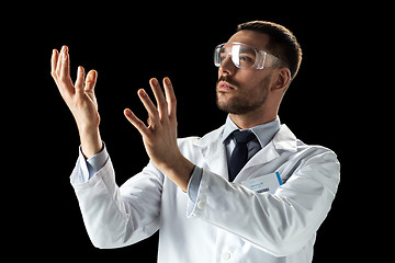 Image showing doctor or scientist in lab coat and safety glasses