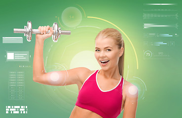 Image showing happy sporty woman with dumbbell flexing biceps