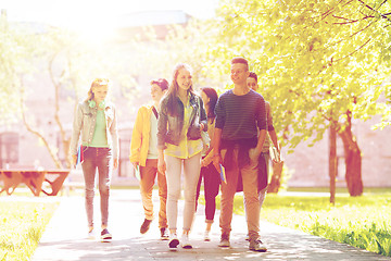 Image showing group of happy teenage students walking outdoors