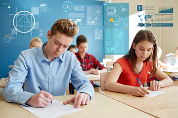 Image showing group of students with books writing school test