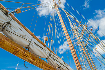 Image showing Folded sail and mast on an old sailboat