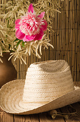 Image showing Straw hat and peony flower, close-up